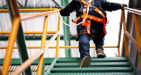 A man working upstairs on a site wearing PPE, demonstrating compliance with Building Safety Act.