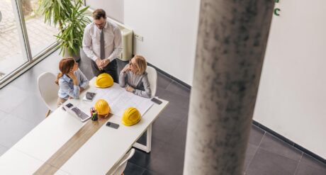 A team in an office discuss the essentials of the building safety act.